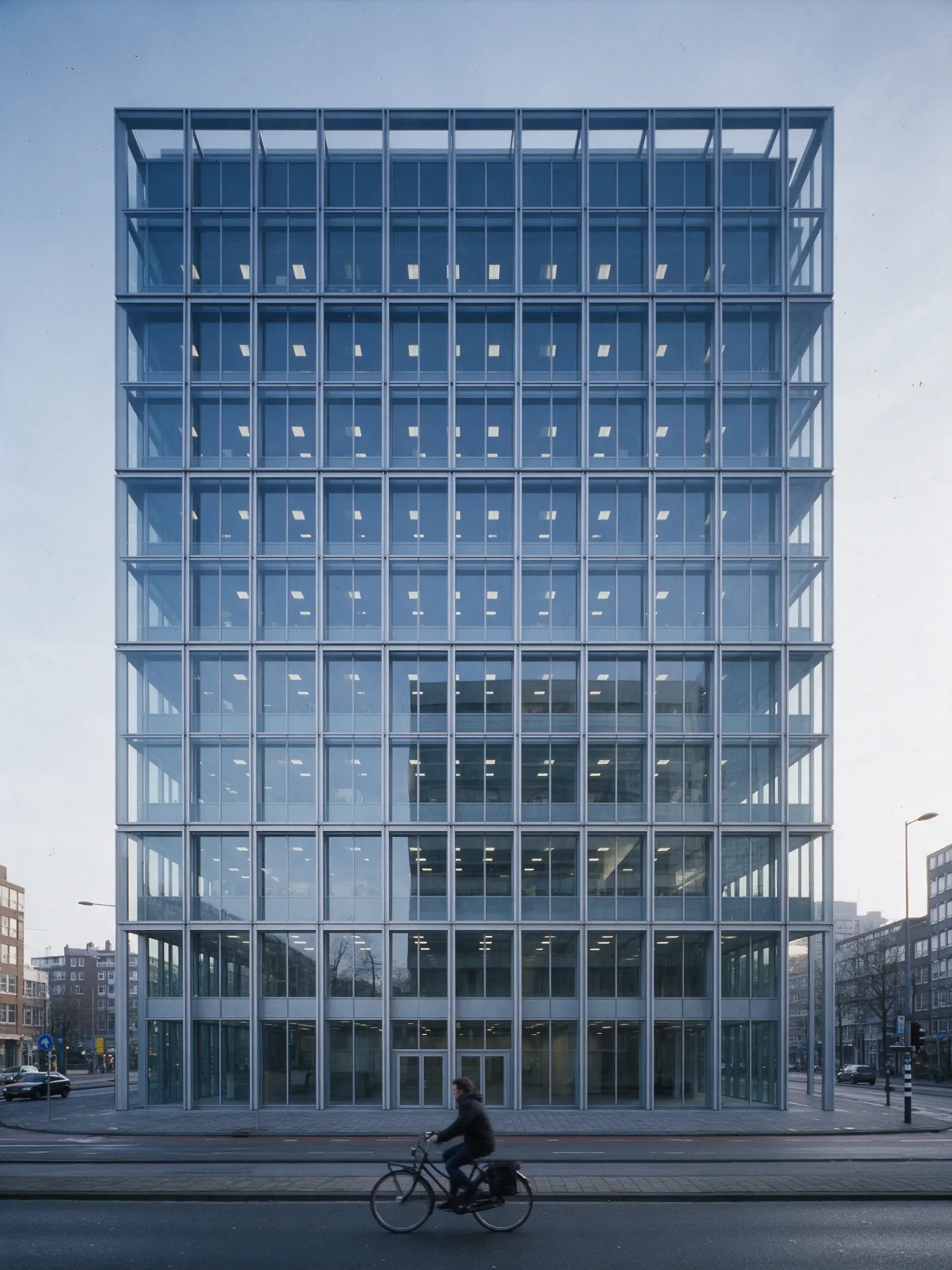 An ordered glass grid façade in Rotterdam in cool morning light